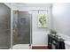 Bathroom featuring a tiled shower with glass door and decorative accents at 15410 N 60Th Ave, Glendale, AZ 85306