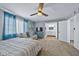 Large carpeted bedroom offering a sitting area and access to an ensuite bathroom at 15410 N 60Th Ave, Glendale, AZ 85306