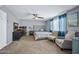 Bedroom showcasing neutral carpet, a cozy seating area, and a ceiling fan at 15410 N 60Th Ave, Glendale, AZ 85306
