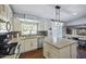 Bright kitchen featuring granite countertops, stainless steel appliances, and a kitchen island at 15410 N 60Th Ave, Glendale, AZ 85306