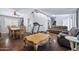 Open-concept living room with hardwood floors flowing into the adjacent dining area at 15410 N 60Th Ave, Glendale, AZ 85306