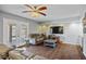 Bright and airy living room with hardwood floors, ceiling fan, and sliding glass door access at 15410 N 60Th Ave, Glendale, AZ 85306