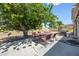Outdoor patio with seating area under a large, shady tree, perfect for entertaining at 15410 N 60Th Ave, Glendale, AZ 85306