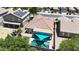 Aerial view of a backyard featuring a pool, sunshade, bar stools, tile roof and solar panels on a neighboring house at 16368 W Cortez St, Surprise, AZ 85388