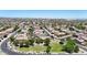 Aerial view of a community showcasing well-maintained homes and landscaping, with a park in the foreground at 16368 W Cortez St, Surprise, AZ 85388