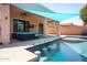 Inviting outdoor space featuring a pool, shaded patio, comfortable seating, and a ceiling fan at 16368 W Cortez St, Surprise, AZ 85388