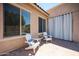 Cozy outdoor patio with seating, perfect for relaxing with a view of the landscaped backyard and pool at 16368 W Cortez St, Surprise, AZ 85388