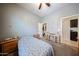 Bright bedroom featuring a ceiling fan, a cozy bed, a wooden desk, and a convenient closet at 16368 W Cortez St, Surprise, AZ 85388