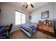 Inviting bedroom boasts a ceiling fan, a bright window, themed decorations, and built-in shelving at 16368 W Cortez St, Surprise, AZ 85388