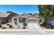 Charming single-story home featuring a well-manicured front yard, desert landscaping, and an attached two-car garage at 16368 W Cortez St, Surprise, AZ 85388
