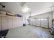 Spacious garage equipped with ample cabinet space for storage and an accessible overhead door at 16368 W Cortez St, Surprise, AZ 85388