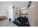 Well-organized garage interior with dedicated workout area and extensive cabinet and tool storage at 16368 W Cortez St, Surprise, AZ 85388