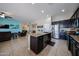 Modern kitchen featuring dark cabinetry, a granite island, and stainless steel appliances at 16368 W Cortez St, Surprise, AZ 85388