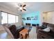 Comfortable living room featuring tile floors, a ceiling fan, and a large window for natural light at 16368 W Cortez St, Surprise, AZ 85388