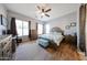 Spacious main bedroom with wood-look floors, stylish ceiling fan, and rustic wood furnishings at 16368 W Cortez St, Surprise, AZ 85388