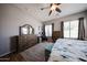 Well-lit main bedroom with wood-look floors, ample storage space, and ceiling fan at 16368 W Cortez St, Surprise, AZ 85388