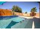Backyard pool featuring water features and in-pool seating, set against a backdrop of lush greenery at 16368 W Cortez St, Surprise, AZ 85388