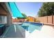 A luxurious pool featuring submerged bar stools and a Baja shelf, perfect for relaxation and entertainment at 16368 W Cortez St, Surprise, AZ 85388