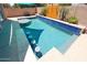 Inviting pool featuring in-pool bar stools and lush landscaping, creating a perfect backyard retreat at 16368 W Cortez St, Surprise, AZ 85388