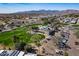 Expansive aerial view showcasing golf course with surrounding residences and desert landscape at 17200 W Bell Rd # 1801, Surprise, AZ 85374