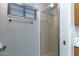 Bright bathroom features glass enclosed shower, towel bar, and window with blinds at 17200 W Bell Rd # 1801, Surprise, AZ 85374