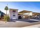 Charming home with carport and desert landscaping, featuring a quaint seating area at 17200 W Bell Rd # 1801, Surprise, AZ 85374