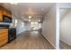Open-concept kitchen and living area with luxury vinyl plank flooring and natural light at 17200 W Bell Rd # 1801, Surprise, AZ 85374