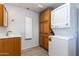 Bright laundry room includes stackable washer and dryer plus ample cabinet space at 17200 W Bell Rd # 1801, Surprise, AZ 85374