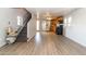 Open-concept living area shows the lift chair, stairs, vinyl flooring, and a view into the kitchen with stainless steel appliances at 17200 W Bell Rd # 1801, Surprise, AZ 85374