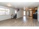 Open-concept living area shows the lift chair, stairs, vinyl flooring, and a view into the kitchen with stainless steel appliances at 17200 W Bell Rd # 1801, Surprise, AZ 85374