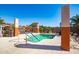 The pool area features a light blue pool, orange accents, and plenty of lounge chairs for residents at 17200 W Bell Rd # 1801, Surprise, AZ 85374