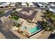 Overhead view of a large pool with lounge chairs, set in a community with desert landscaping at 17200 W Bell Rd # 1801, Surprise, AZ 85374