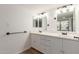 The bathroom has a double vanity with white cabinets, providing ample space for your morning and evening routine at 1822 S River Dr, Tempe, AZ 85281