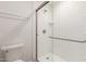 Bathroom showcasing white subway tile in the shower with glass enclosure, toilet, and chrome fixtures at 1822 S River Dr, Tempe, AZ 85281