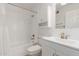 Bright bathroom featuring white subway tile, shower-tub combo, and a white vanity at 1822 S River Dr, Tempe, AZ 85281