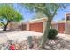 Exterior view of garages featuring stucco exteriors and low maintenance desert landscaping at 1822 S River Dr, Tempe, AZ 85281