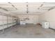 Spacious garage with laundry area, storage shelves, and ample room for vehicles at 1822 S River Dr, Tempe, AZ 85281