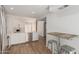 Open-concept design showcases the kitchen's sleek appliances, white cabinetry, and adjacent breakfast bar for casual dining at 1822 S River Dr, Tempe, AZ 85281