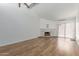 Bright, spacious living room featuring hardwood flooring and a brick fireplace at 1822 S River Dr, Tempe, AZ 85281
