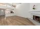 Open concept living room with view of the kitchen, fireplace and hardwood flooring at 1822 S River Dr, Tempe, AZ 85281