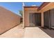 Back patio with sliding door access featuring concrete and brick, walled for privacy at 1822 S River Dr, Tempe, AZ 85281