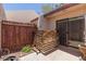 A private back patio with wooden fencing and a sliding glass door entry to the home at 1822 S River Dr, Tempe, AZ 85281