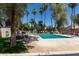 Community pool surrounded by mature landscaping, trees, and poolside seating at 1822 S River Dr, Tempe, AZ 85281