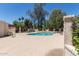 Community pool surrounded by mature landscaping, trees, and poolside seating at 1822 S River Dr, Tempe, AZ 85281