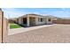 Beautiful backyard featuring an artificial lawn and low maintenance gravel at 18854 W Poinsettia Dr, Surprise, AZ 85388