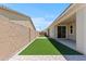 Lush artificial turf in this modern backyard is perfect for relaxing and entertaining at 18854 W Poinsettia Dr, Surprise, AZ 85388