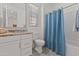Bathroom with shower-tub combo with curtain, and white vanity at 18854 W Poinsettia Dr, Surprise, AZ 85388