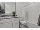 Clean, modern bathroom with granite countertop, white cabinetry, and tub with shower at 18854 W Poinsettia Dr, Surprise, AZ 85388