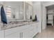 Elegant bathroom with double vanity, granite countertops, and a large mirror at 18854 W Poinsettia Dr, Surprise, AZ 85388