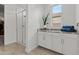 Modern bathroom with a walk-in glass shower, storage cabinets, and granite countertop at 18854 W Poinsettia Dr, Surprise, AZ 85388